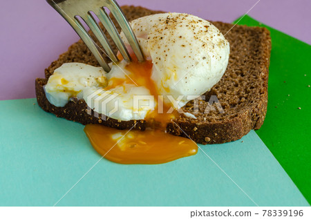Fork pierced the egg white. Fork pierced the egg white. 78339196