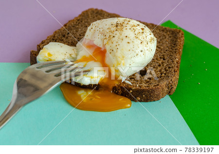 Soft-boiled egg on a slice of rye bread. Soft-boiled egg on a slice of rye bread. 78339197