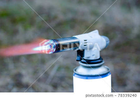 Closeup of a nozzle with a scarlet flame. 78339240