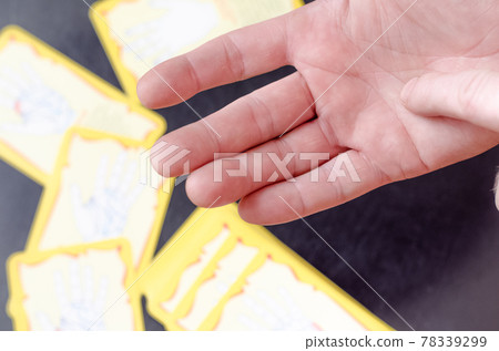 Chiromancer reads the lines on a male hand. 78339299