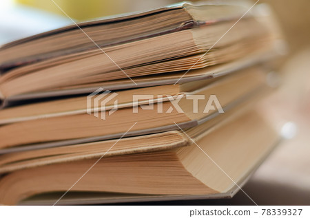 A large stack of open textbooks on the table. A large stack of open textbooks on the table. 78339327
