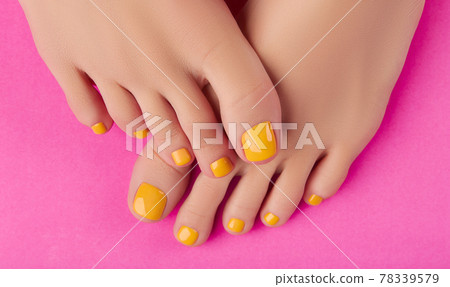 Womans feet with spring summer nail design on pink background. Body treatment Womans feet with spring summer nail design on pink background. Body treatment 78339579