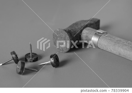 Old hammer and nails on a grey background. Old hammer and nails on a grey background. 78339904