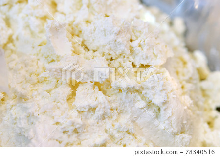 Crumbly cottage cheese on a store counter. Crumbly cottage cheese on a store counter. 78340516