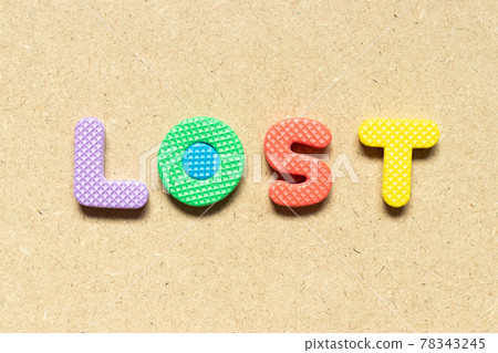 Foam alphabet letter in word lost on wood background Foam alphabet letter in word lost on wood background 78343245