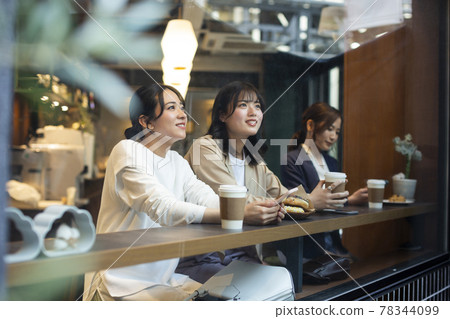 Young woman spending time in a cafe Young woman spending time in a cafe 78344099