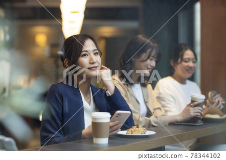 Young woman spending time in a cafe Young woman spending time in a cafe 78344102