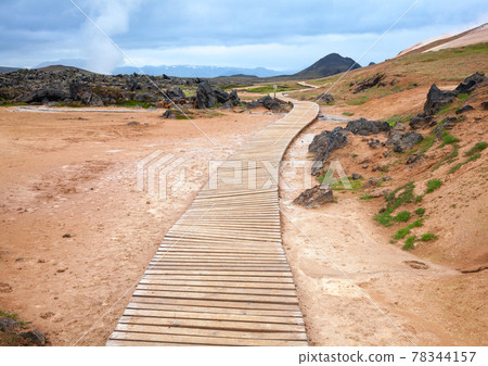 Wooden boardwalk in volcanic area 78344157