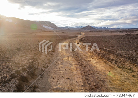 Winding gravel road through Odaddahraun lava field Highlands of Iceland Scandinavia 78344467