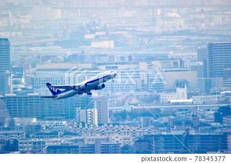 Boeing 767-300, a passenger plane taking off against a large city 78345377