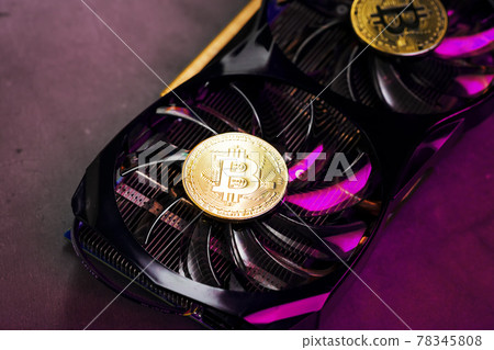 On the fans of a powerful video card, the coins of the Bitcoin cryptocurrency with a red On the fans of a powerful video card, the coins of the Bitcoin cryptocurrency with a red 78345808