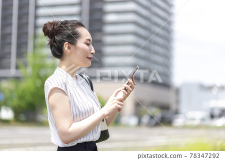 Business woman with a smartphone Business woman with a smartphone 78347292