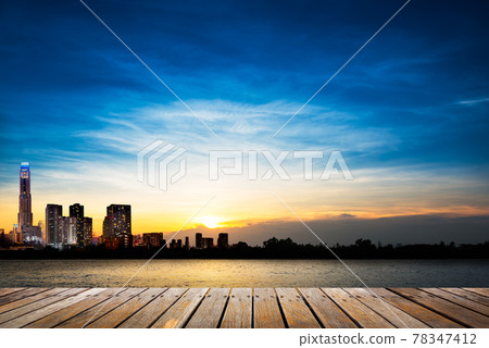 Wooden walkway on city and sunset background 78347412