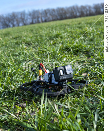 A Brand-New Modern Cinewhoop Iflight Protek 35 with GoPro Action Camera on Board Outdoors in the Grass A Brand-New Modern Cinewhoop Iflight Protek 35 with GoPro Action Camera on Board Outdoors in the Grass 78348870