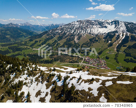 Aerial view on the village of Oberjoch in the Allgau Alps on a sunny day in May with last snow in the higher mountains 78348965
