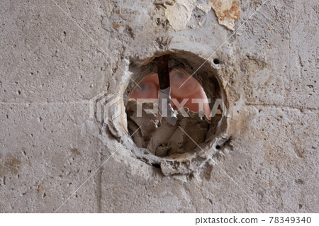 Repairing the wall - Man putting spackle on a hole in the wall Repairing the wall - Man putting spackle on a hole in the wall 78349340