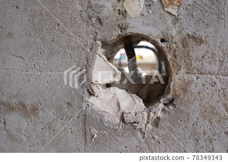 Repairing the wall - Man putting spackle on a hole in the wall Repairing the wall - Man putting spackle on a hole in the wall 78349343