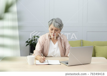 Elderly professional woman working from home during covid-19 pandemic Elderly professional woman working from home during covid-19 pandemic 78349418