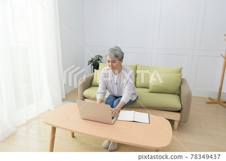 Elderly professional woman working from home during covid-19 pandemic 78349437