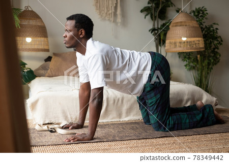 African man working out, yoga, pilates, fitness training, bend in Cow yoga posture 78349442