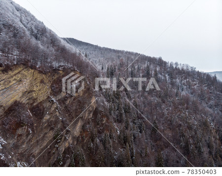 Wonderful landscapes of the Carpathian Mountains covered with snow at Cloudy Day in Ukraine near the village of Vyzhnytsia and River Cheremosh Wonderful landscapes of the Carpathian Mountains covered with snow at Cloudy Day in Ukraine near the village of Vyzhnytsia and River Cheremosh 78350403
