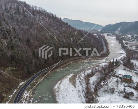 Wonderful landscapes of the Carpathian Mountains covered with snow at Cloudy Day in Ukraine near the village of Vyzhnytsia and River Cheremosh Wonderful landscapes of the Carpathian Mountains covered with snow at Cloudy Day in Ukraine near the village of Vyzhnytsia and River Cheremosh 78350406
