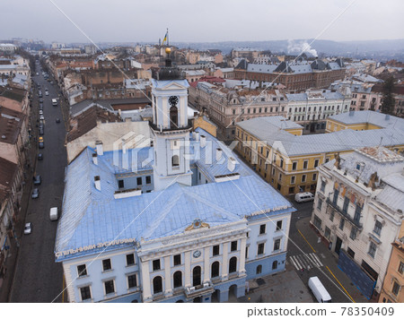 Aerial view of central part and City Hall of beautiful ancient ukrainian city Chernivtsi with its streets, old residential buildings, town hall, churches etc Aerial view of central part and City Hall of beautiful ancient ukrainian city Chernivtsi with its streets, old residential buildings, town hall, churches etc 78350409