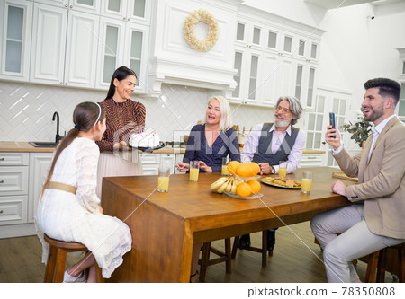 Loving mom bringing cake for little daughters birthday celebration Loving mom bringing cake for little daughters birthday celebration 78350808