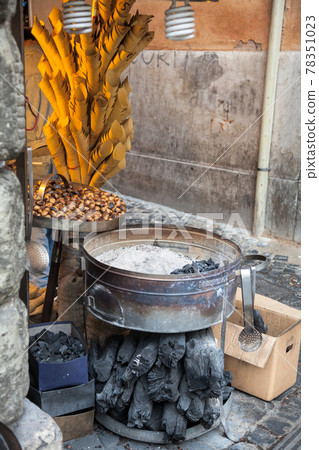 Roasted chestnuts street vendor stall Roasted chestnuts street vendor stall 78351023