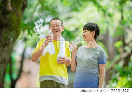 Senior couple outdoor hydration walking 78351877
