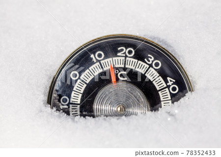 Thermometer in a snow warm winter weather global warming concept 78352433