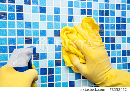 Wiping bathroom wall with cleaning cloth and sprayer - house chores Wiping bathroom wall with cleaning cloth and sprayer - house chores 78352452