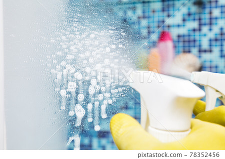 Spraying disinfectant on bathroom mirror protective measures against coronavirus epidemy Spraying disinfectant on bathroom mirror protective measures against coronavirus epidemy 78352456