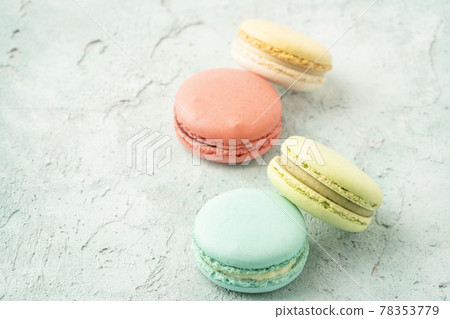 colorful macaroons on green background with copy space 78353779