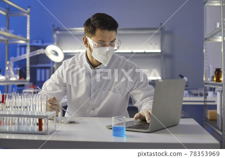Scientist doing research and working on a laptop computer in a science laboratory Scientist doing research and working on a laptop computer in a science laboratory 78353969