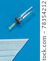 Blue background with surgical mask 78354212