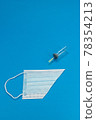 Blue background with surgical mask 78354213