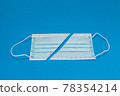 Blue background with surgical mask 78354214