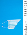 Blue background with surgical mask 78354215
