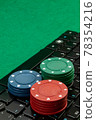 Gambling chips on computer keyboard on green background 78354216