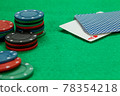 Gambling chips on computer keyboard on green background 78354218