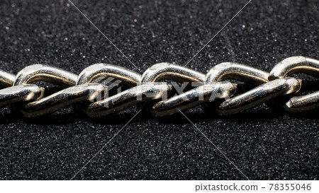 Chain links close up on black background Chain links close up on black background 78355046