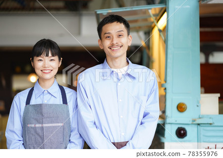 A couple standing in front of a kitchen car 78355976