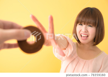 A young woman who is confused by being robbed of a snack 78359160