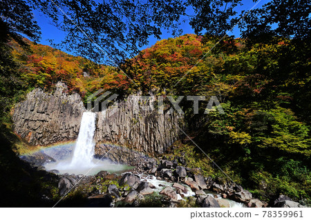 A rainbow appears in the Naena Waterfall basin of autumn leaves A rainbow appears in the Naena Waterfall basin of autumn leaves 78359961