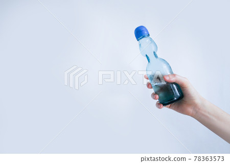 Hand holding a ramune bottle Hand holding a ramune bottle 78363573