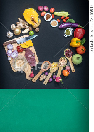 .top view Fresh food is placed on a black table with a green cloth on the side. .top view Fresh food is placed on a black table with a green cloth on the side. 78365915