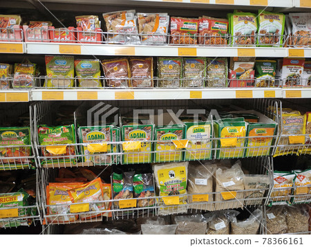 PENANG, MALAYSIA -JANUARY 5, 2021: Selected focused on the spices are sold in commercial packages and displayed on shelves in the supermarket. Sort by brand and type to make it easier to choose.  78366161