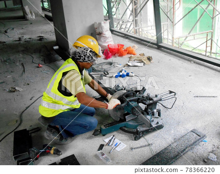 KUALA LUMPUR, MALAYSIA -JUNE 18, 2020: Mobile circular cutter used by the carpenter to cut plywood at the construction site.   78366220