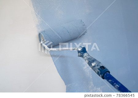 Paint roller by wall during home renovation. 78366545